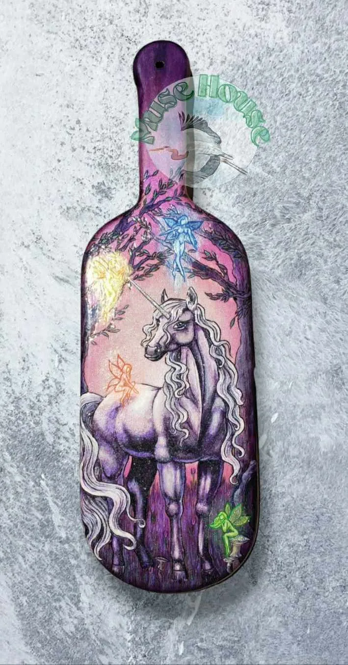 wooden paddle with unicorn design